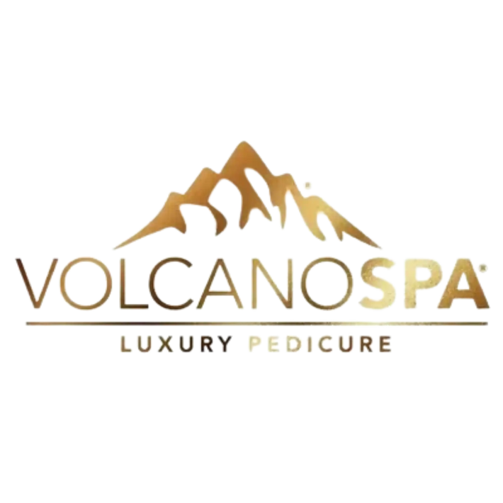 Logo for Volcano Spa luxury pedicure service featuring stylized golden mountain peaks.