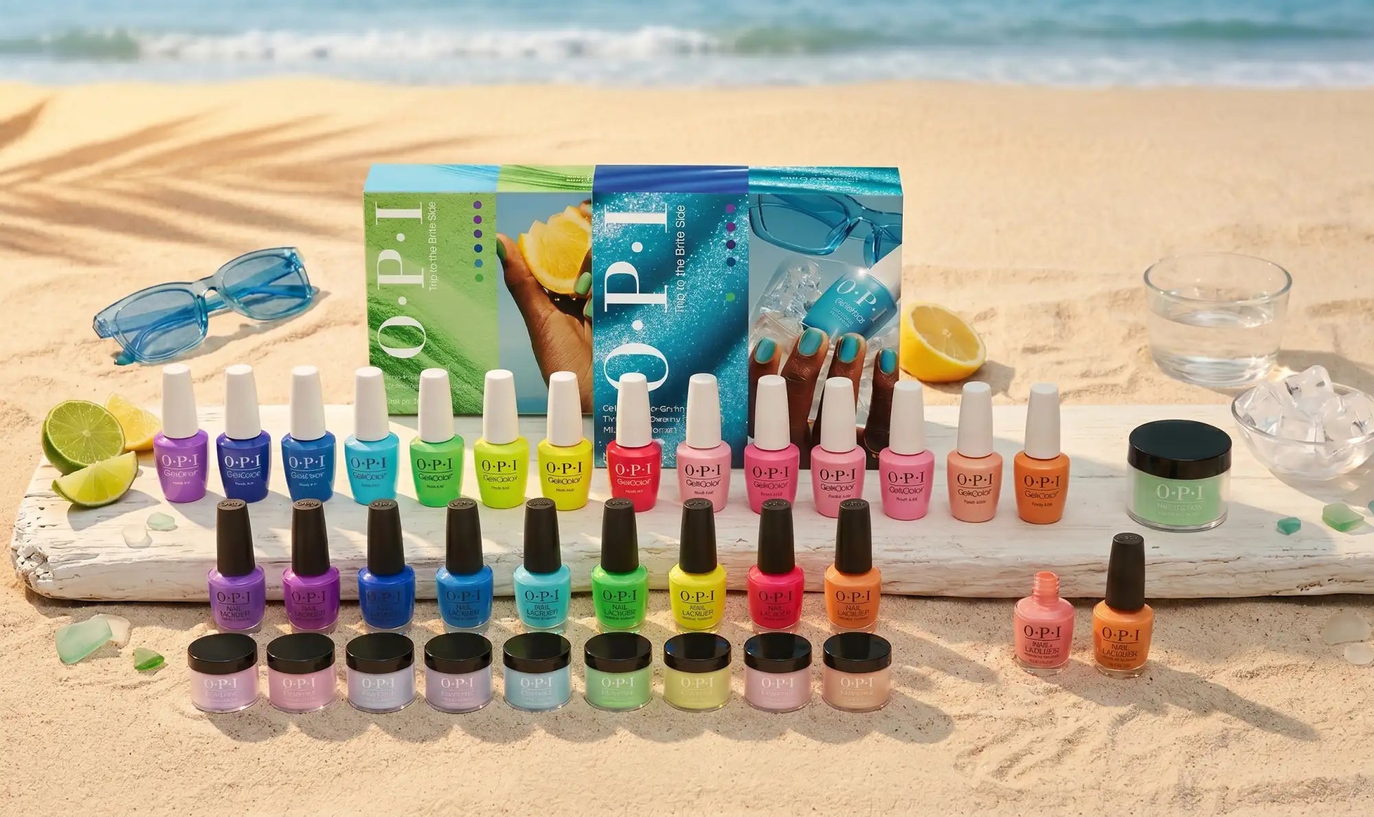 A vibrant collection of opi nail polishes in assorted bright colors, displayed on a beach with sunglasses and lemons nearby.